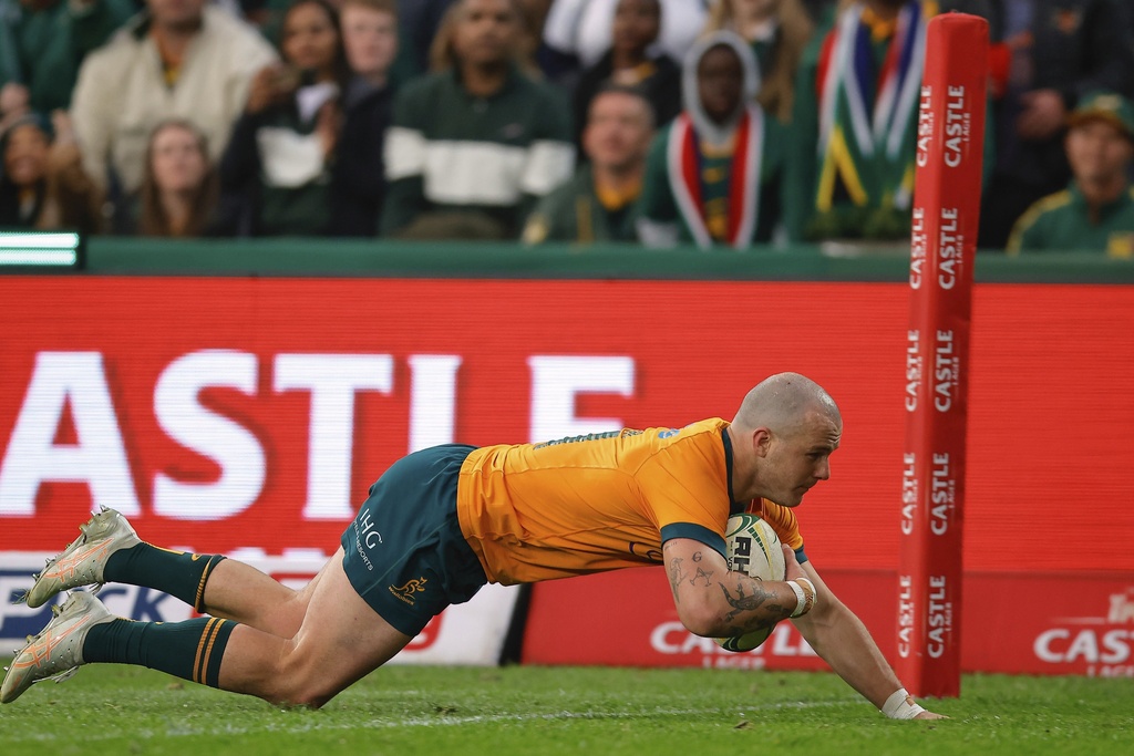 Australia's Dylan Pietsch dives over the line to score a try during a rugby championship test match between South Africa and Australia, at Ellis Park stadium in Johannesburg, South Africa, Saturday, Aug. 16, 2025. (AP Photo/Frans Lombard)