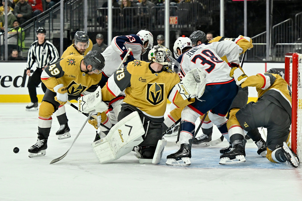 Vegas Golden Knights goaltender Carter Hart (79) defends the net against Columbus Blue Jackets players during the first period of an NHL hockey game Thursday, Jan. 8, 2026, in Las Vegas. (AP Photo/David Becker)