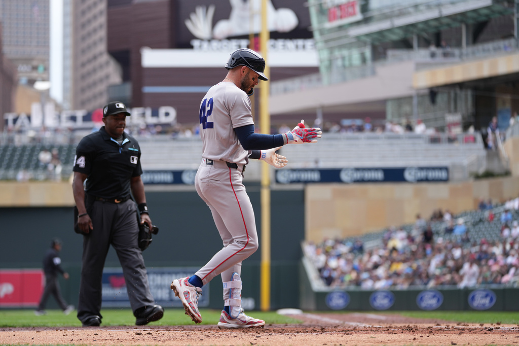 Boston Red Sox's Trevor Story crosses home plate after hitting a three-run home run during the third inning of a baseball game against the Minnesota Twins,Wednesday, April 15, 2026, in Minneapolis. (AP Photo/Abbie Parr)
