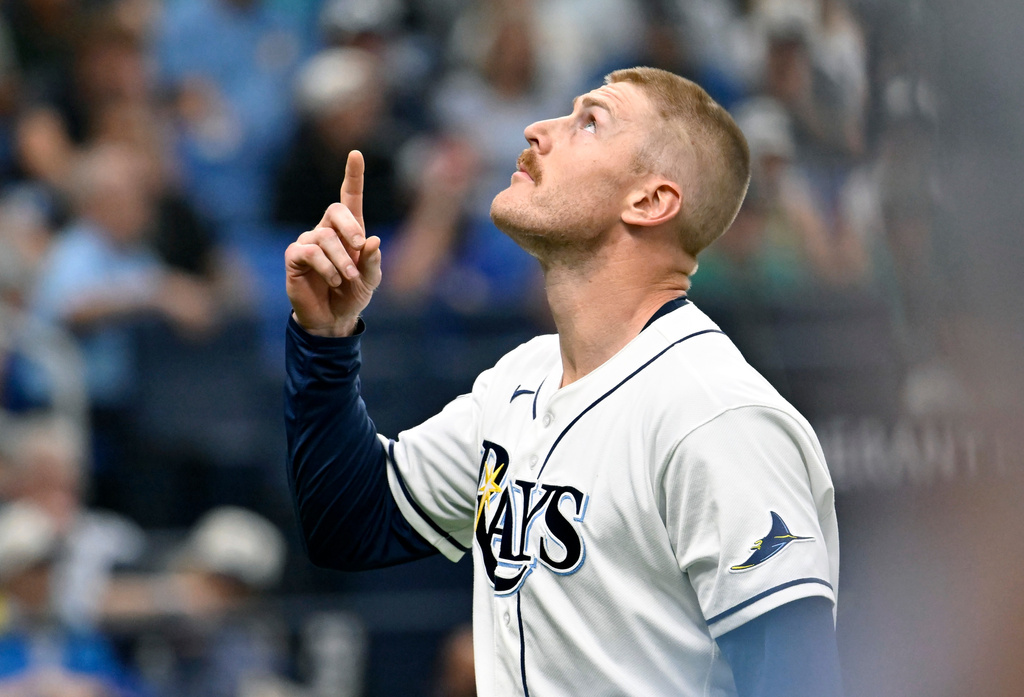 Tampa Bay Rays pitcher Cam Booser celebrates as he comes to the dugout after striking out Seattle Mariners' J.P. Crawford during the seventh inning of a baseball game Saturday, July 11, 2026, in St. Petersburg, Fla. (AP Photo/Jason Behnken)