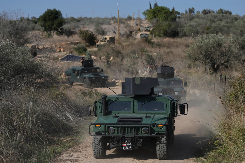 A convoy of Lebanese army vehicles drives near the border with Israel in the village of Alma al-Shaab during a Lebanese army media tour in south Lebanon, Friday, Nov. 28, 2025. (AP Photo/Bilal Hussein)