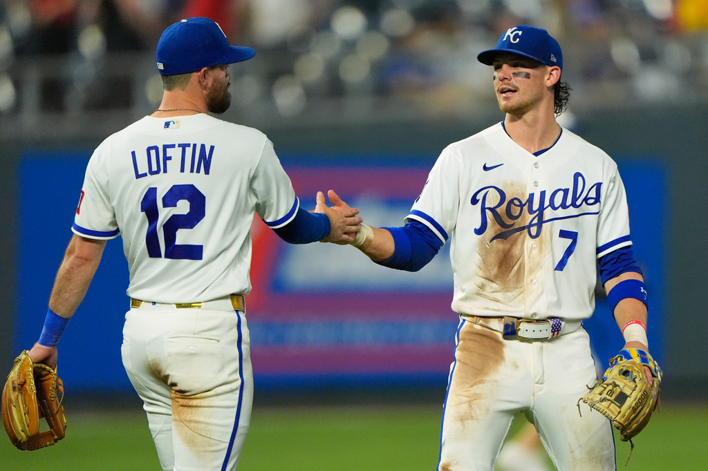 Kansas City Royals' Bobby Witt Jr. (7) and Nick Loftin (12) celebrate after their baseball game against the Minnesota Twins, Tuesday, Aug. 4, {t yr4}, in Kansas City, Mo. (AP Photo/Charlie Riedel)
