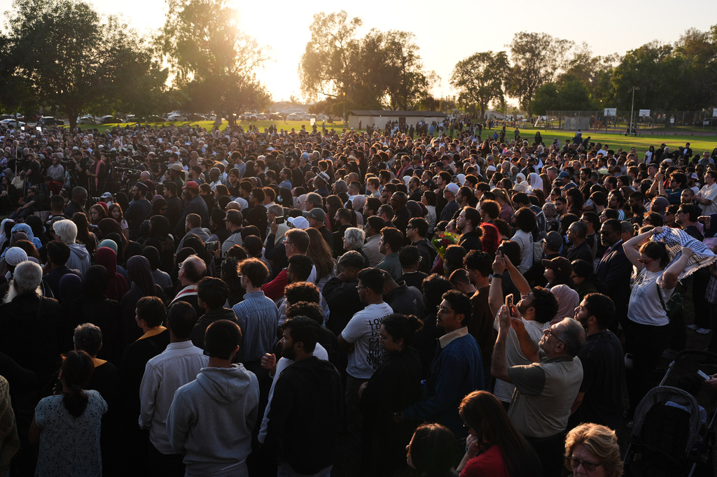 People attend a vigil, the day after a shooting, outside of the Islamic Center of San Diego, Tuesday, May 19, 2026, in San Diego. (AP Photo/Jae C. Hong)