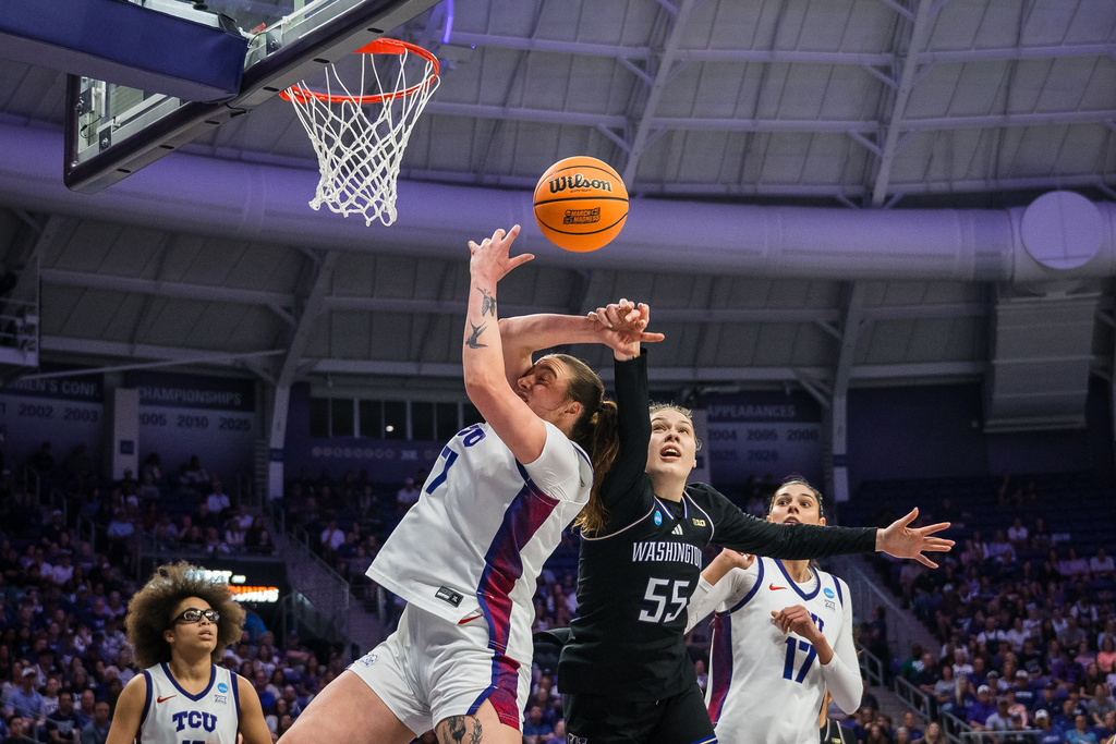 Washington center Yulia Grabovskaia (55) and TCU forward Marta Suárez (7) go for a rebound during the first half in the second round of the NCAA college basketball tournament Sunday, March 22, 2026, Fort Worth, Texas. (AP Photo/Jessica Tobias)