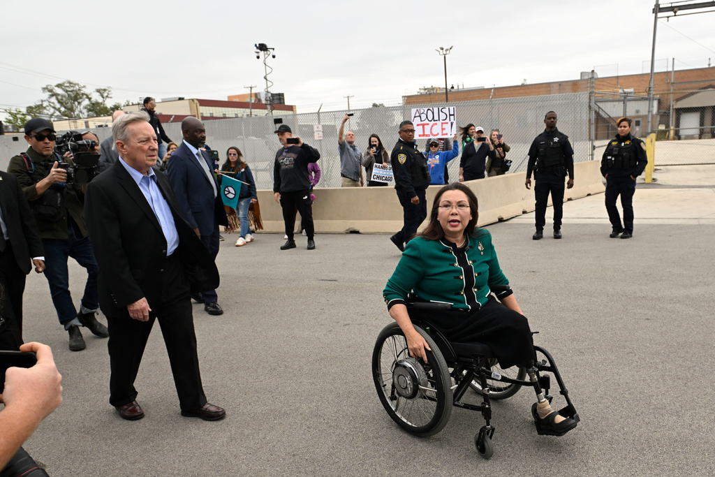 Sen. Tammy Duckworth, D-Ill., and Sen. Dick Durbin, D-Ill., speak to protestors outside the U.S. Immigration and Customs Enforcement facility in Broadview, Ill., Friday, Oct. 10, 2025. (AP Photo/Paul Beaty)