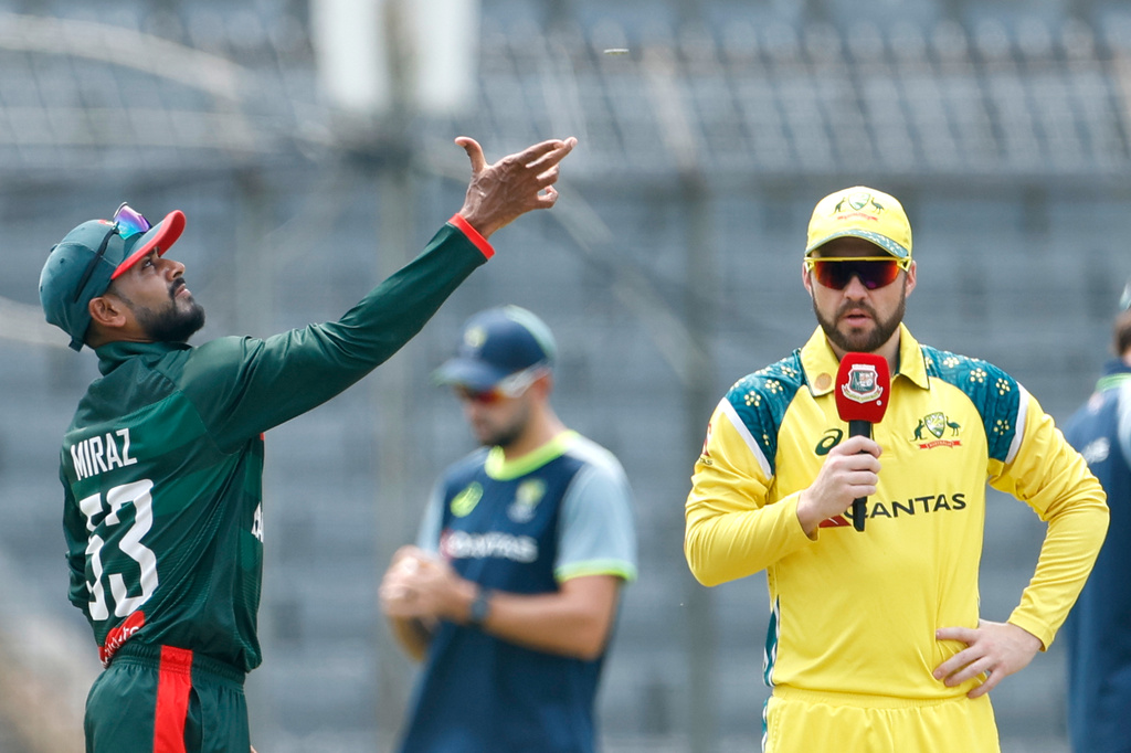 Bangladesh's captain Mehidy Hasan Miraz, left, tosses the coin for the toss as Australia's captain Josh Inglis looks during the second one day international cricket match between Australia and Bangladesh in Mirpur, Bangladesh, Thursday, June 11, 2026. (AP Photo/Mosaraf Hossain)