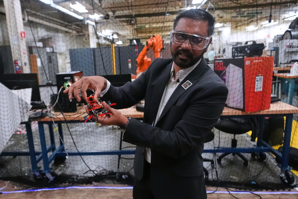 Nitan Sanket, assistant professor of robotics engineering, describes the components on a tiny drone at his lab at Worcester Polytechnic Institute, Monday, Oct. 20, 2025, in Worcester, Mass. (AP Photo/Charles Krupa)