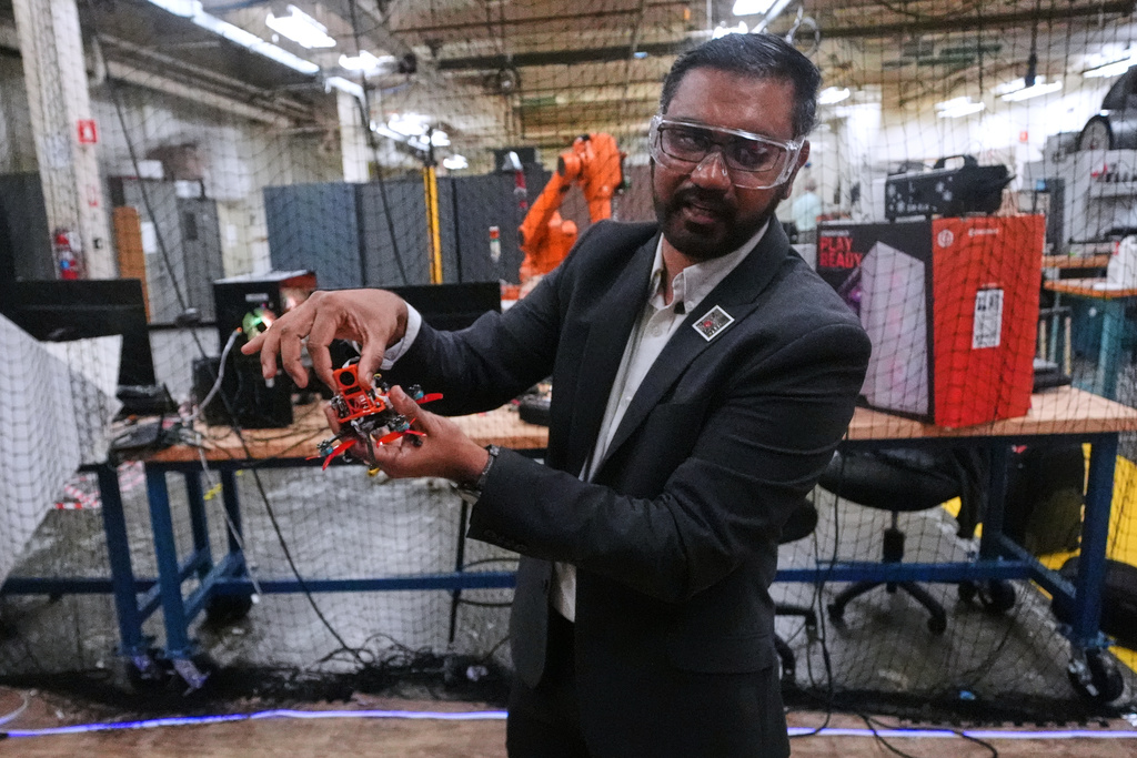 CORRECTS SPELLING OF NAME TO NITIN NOT NITAN Nitin Sanket, assistant professor of robotics engineering, describes the components on a tiny drone at his lab at Worcester Polytechnic Institute, Monday, Oct. 20, 2025, in Worcester, Mass. (AP Photo/Charles Krupa)