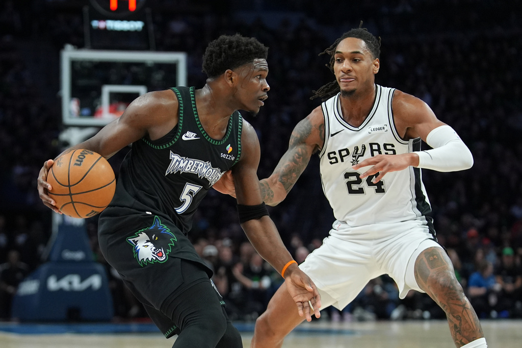 Minnesota Timberwolves guard Anthony Edwards (5) drives against San Antonio Spurs guard Devin Vassell (24) during the first half of Game 4 of an NBA basketball second-round playoffs series in Minneapolis, Sunday, May 10, 2026. (AP Photo/Abbie Parr)