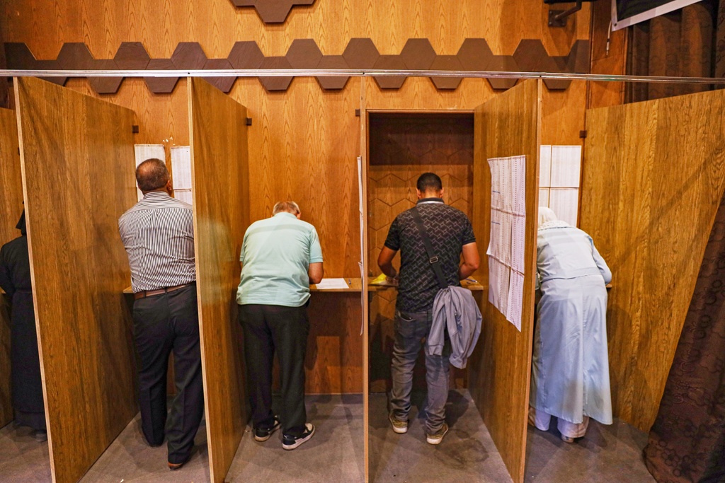 Electoral college members collect their ballots for a parliamentary election at a polling station in Aleppo, Syria, Sunday, Oct. 5, 2025. (AP Photo/Omar Albam)