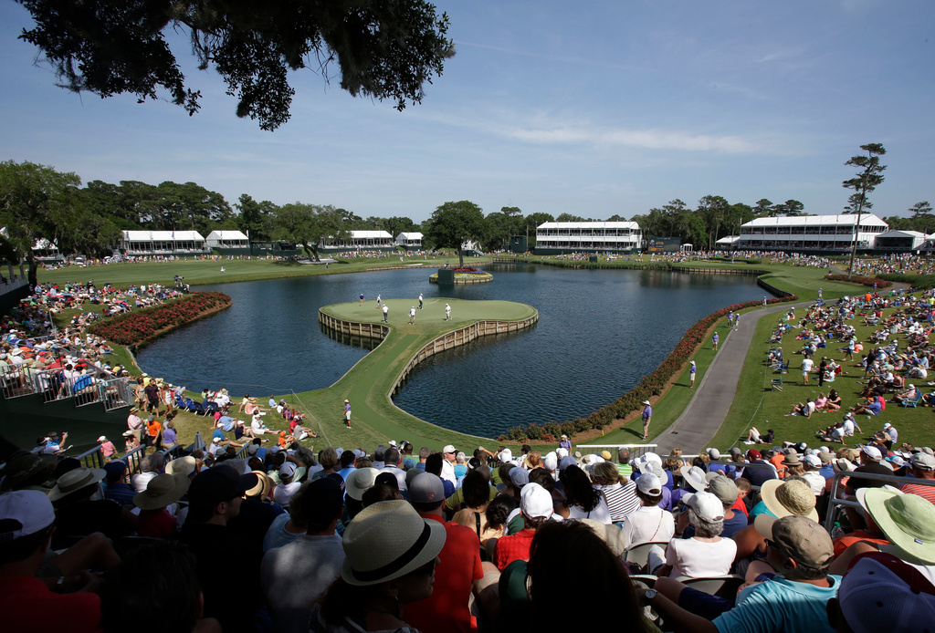 FILE -Golfers play the 17th hole during the second round of The Players championship golf tournament at TPC Sawgrass, May 9, 2014, in Ponte Vedra Beach, Fla. (AP Photo/John Raoux, File)