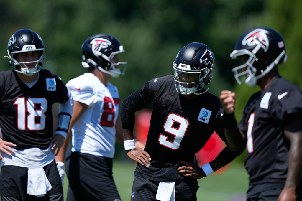 Atlanta Falcons quarterbacks Michael Penix Jr. (9) Jack Strand (18) and Tua Tagovailoa (1) run drills during an NFL football training camp practice Monday, Aug. 24, 2026, in Flowery Branch, Ga. (AP Photo/Brynn Anderson)