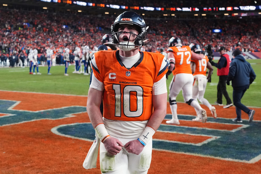 Denver Broncos quarterback Bo Nix celebrates after a touchdown during the second half of an NFL divisional round playoff football game against the Buffalo Bills, Wednesday, Jan. 17, 2024, in Denver. (AP Photo/David Zalubowski)