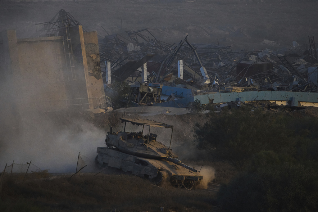 Israeli soldiers drive a tank inside the Gaza Strip as seen from southern Israel, Wednesday, Sept. 3, 2025. (AP Photo/Ariel Schalit)