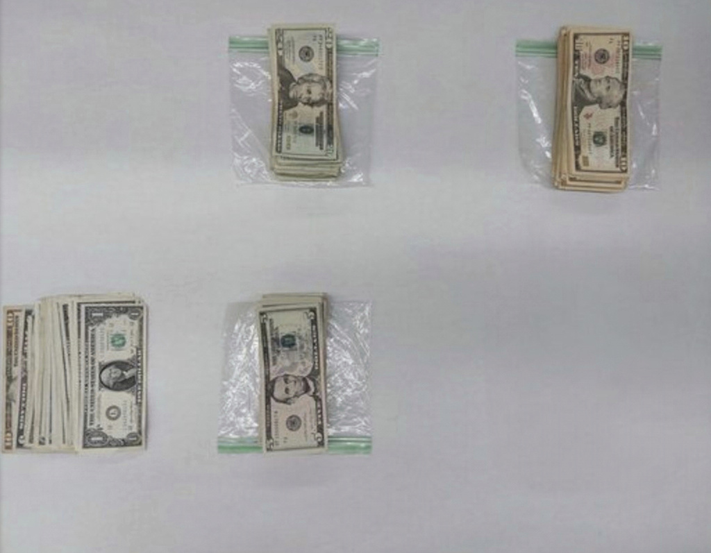 This image provided by the San Francisco Police Department shows cash that is part of the evidence collected in an investigation into bank robberies on Sept. 10. (San Francisco Police Department via AP)