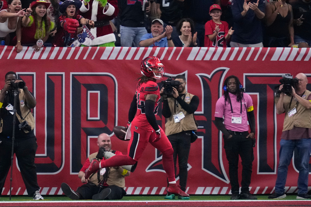 Houston Texans cornerback Derek Stingley Jr. celebrates after returning an interception for a touchdown during the first half of an NFL football game against the Las Vegas Raiders, Sunday, Dec. 21, 2025, in Houston. (AP Photo/Ashley Landis)