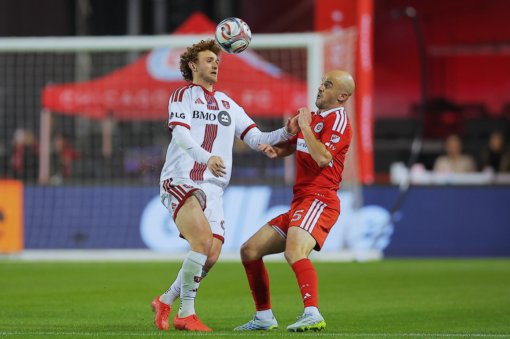 Toronto FC forward Josh Sargent, left, and Chicago Fire defender Andrew Gutman battle for the ball during the second half of an MLS soccer match Saturday, May 23, 2026, in Chicago. (AP Photo/Melissa Tamez)