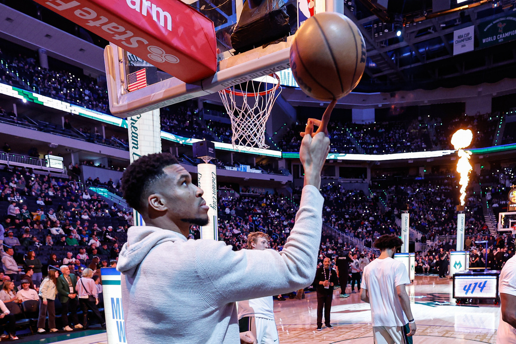 Milwaukee Bucks forward Giannis Antetokounmpo (34) spins the ball on his finger before an NBA basketball game against the Brooklyn Nets Friday, April 10, 2026, in Milwaukee. (AP Photo/Jeffrey Phelps)