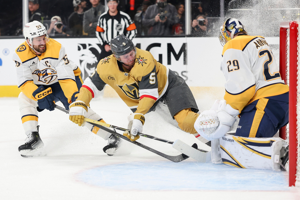Vegas Golden Knights defenseman Jeremy Lauzon (5) collides into Nashville Predators goaltender Justus Annunen (29) while skating against Predators defenseman Roman Josi (59) during the second period of an NHL hockey game Saturday, Jan. 17, 2026, in Las Vegas. (AP Photo/Ian Maule)