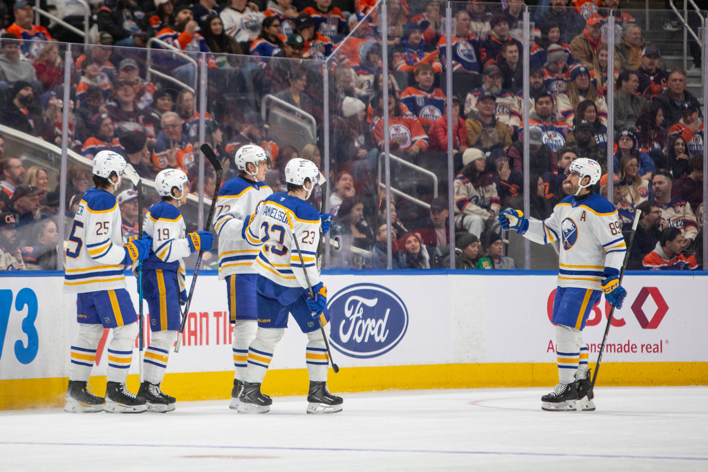 Buffalo Sabres Alex Tuch (89) celebrates a goal with Mattias Samuelsson (23), Tage Thompson (72), Peyton Krebs (19), and Owen Power (25) during the second period of an NHL hockey game against the Edmonton Oilers in Edmonton, Alberta, Tuesday, Dec. 9, 2025. (Amber Bracken/The Canadian Press via AP)