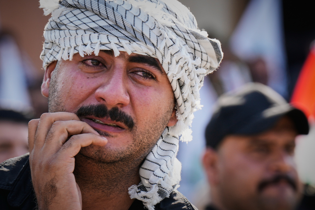 A mourner weeps during a group funeral for Iranian advisers and Popular Mobilization Forces fighters killed in airstrikes on bases belonging to Iraq's Popular Mobilization Forces, a coalition of predominantly Shiite militias that includes Iran-backed groups, in Mosul, Iraq, Wednesday, July 29, 2026. (AP Photo/Hadi Mizban)