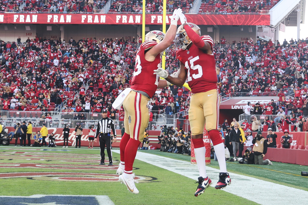 San Francisco 49ers wide receiver Jauan Jennings (15) celebrates his touchdown with running back Christian McCaffrey, left, during the second half of an NFL football game against the Tennessee Titans, Sunday, Dec. 14, 2025, in Santa Clara, Calif. (AP Photo/Jed Jacobsohn)