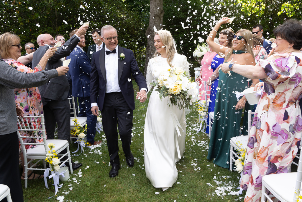 Australian Prime Minister Anthony Albanese, center left, and Jodie Haydon, center right, are showered with confetti after getting married in Canberra, Saturday, Nov. 29, 2025.(Mike Bowers/Pool Photo via AP)