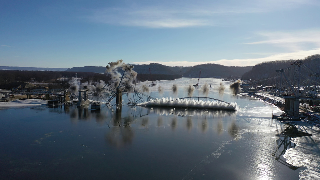 This photo provided by Iowa Department of Transportation shows the implosion of the 94-year-old Black Hawk Bridge over the Mississippi River between Iowa and Wisconsin on Friday, Dec. 19, 2025. (Iowa Department of Transportation via AP)