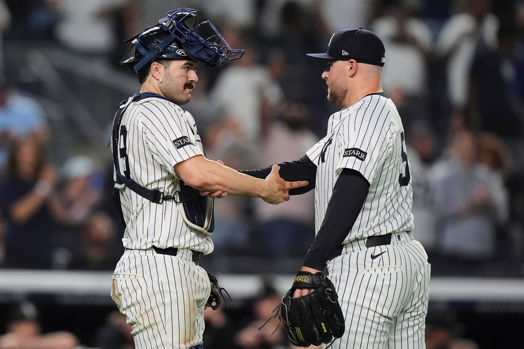 New York Yankees pitcher David Bednar, right, and catcher Austin Wells celebrate after a baseball game against the Chicago White Sox Thursday, Sept. 25, 2025, in New York. (AP Photo/Frank Franklin II)