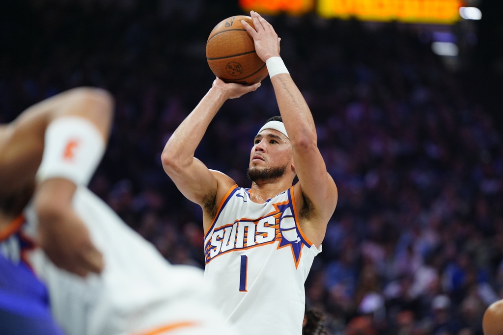 Phoenix Suns guard Devin Booker (1) shoots a free throw during the first half of an Emirates NBA Cup basketball game Wednesday, Nov. 26, 2025, in Sacramento, Calif. (AP Photo/Alan Greth)