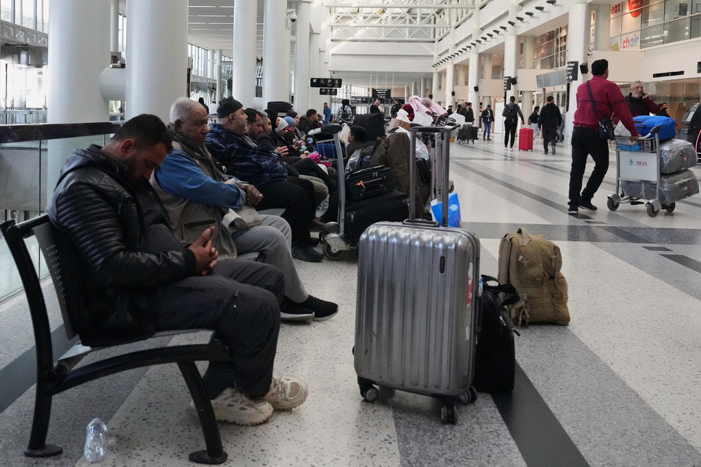 Passengers whose flights were cancelled, wait at the departure terminal of Rafik Hariri International Airport in Beirut, Lebanon, Saturday, Feb. 28, 2026, as many airlines canceled flights due to the conflict involving the United States, Israel and Iran. (AP Photo/Hassan Ammar)