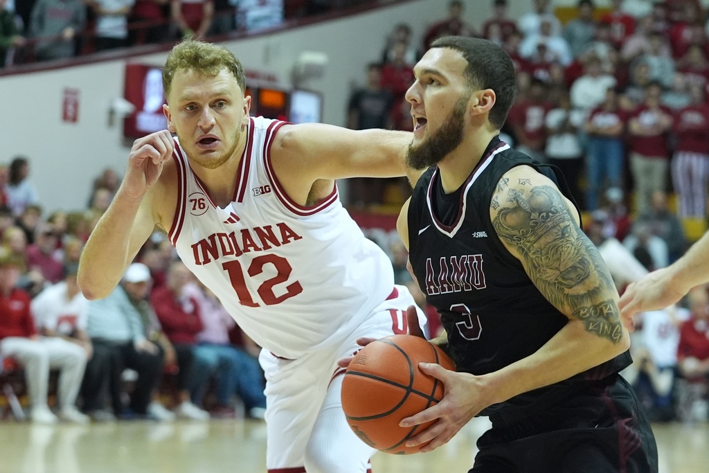 Alabama A&M's Sami Pissis (3) goes to the basket against Indiana's Tucker Devries (12) during the first half of an NCAA college basketball game, Wednesday, Nov. 5, 2025, in Bloomington, Ind. (AP Photo/Darron Cummings)