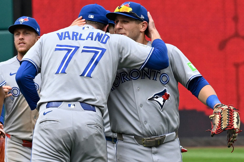 Toronto Blue Jays closing pitcher Louis Varland (77) receives a hug from Daulton Varsho after the Blue Jays defeated the Washington Nationals in a baseball game, Wednesday, July 29, 2026, in Washington. (AP Photo/John McDonnell)