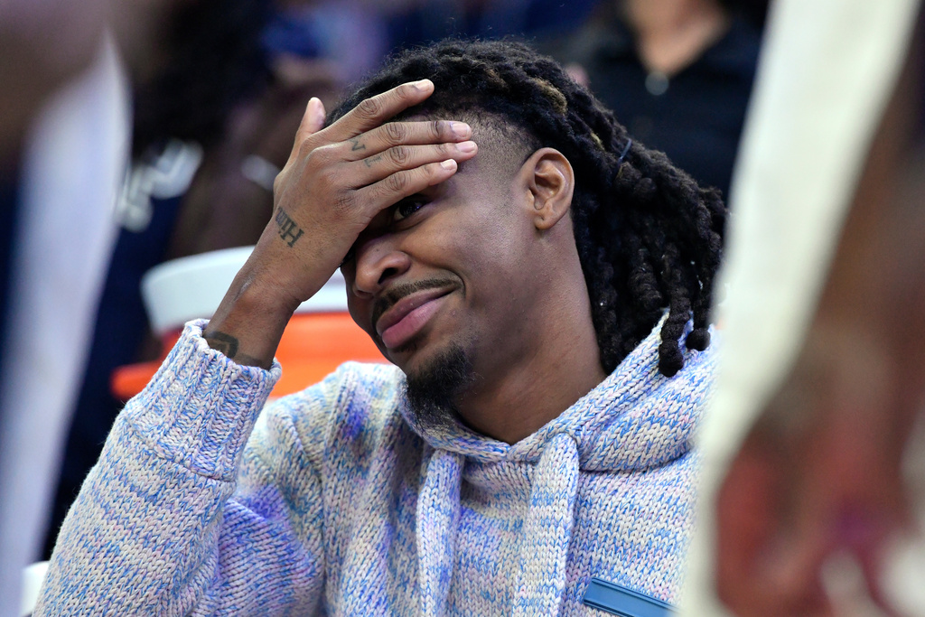 Memphis Grizzlies guard Ja Morant looks on from the bench in the second half of an NBA basketball game against the New Orleans Pelicans, Friday, Jan. 23, 2026, in Memphis, Tenn. (AP Photo/Brandon Dill)