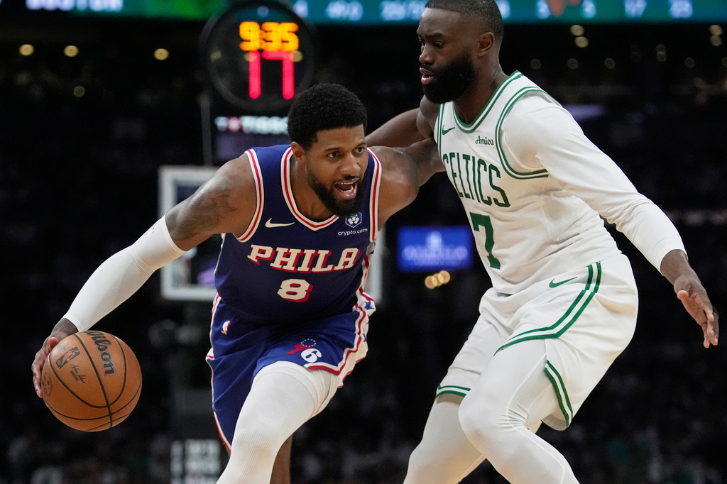 FILE - Philadelphia 76ers forward Paul George (8) drives around Boston Celtics guard Jaylen Brown (7) during the second half in Game 1 of a first-round NBA playoffs basketball game, Sunday, April 19, 2026, in Boston. (AP Photo/Robert F. Bukaty)