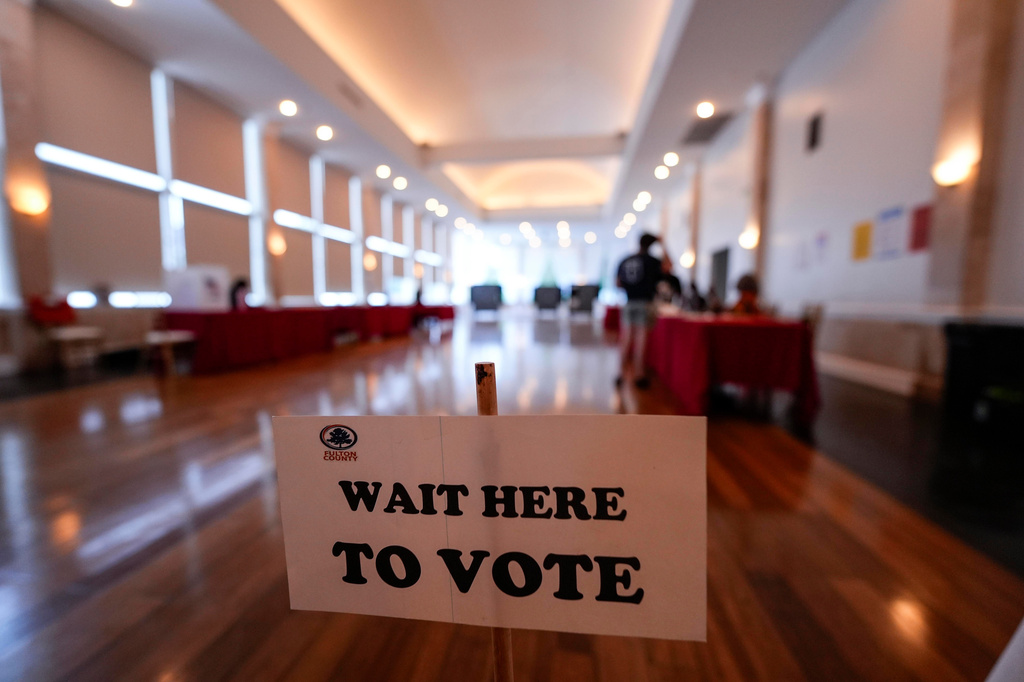 People vote in a runoff election at Park Tavern, Tuesday, June 16, 2026, in Atlanta. (AP Photo/Mike Stewart)