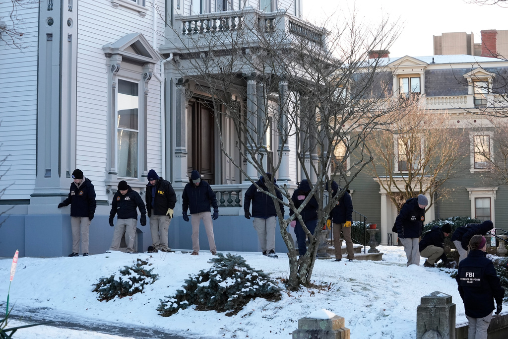Members of the FBI Evidence Response Team search for evidence near the campus of Brown University, Monday, Dec. 15, 2025, in Providence, R.I. (AP Photo/Robert F. Bukaty)