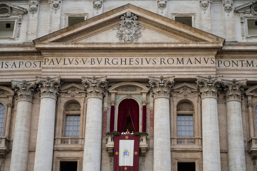Pope Leo XIV delivers the Urbi et Orbi (Latin for 'to the city and to the world' ) Christmas' day blessing from the main balcony of St. Peter's Basilica at the Vatican, Thursday, Dec. 25, 2025. (AP Photo/Gregorio Borgia)