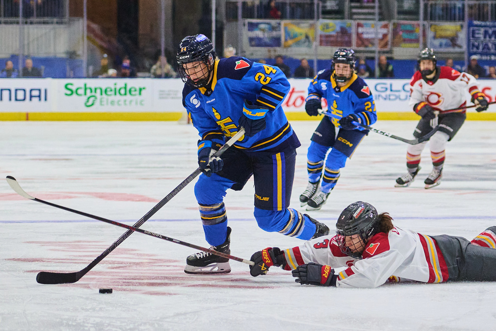 Ottawa Charge's Jocelyne Larocque (3) dives for the puck as she defends against Toronto Sceptres' Natalie Spooner (24) during second period PWHL hockey action in Toronto, Tuesday, Dec. 23, 2025. (Sammy Kogan/The Canadian Press via AP)