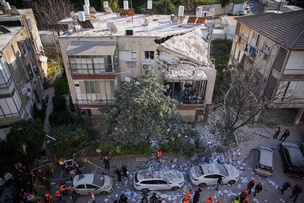 Officers from Israel's Home Front Command inspect a damaged apartment building after an Iranian missile strike in Ramat Gan, Israel, Tuesday, March 3, 2026. (AP Photo/Ohad Zwigenberg)