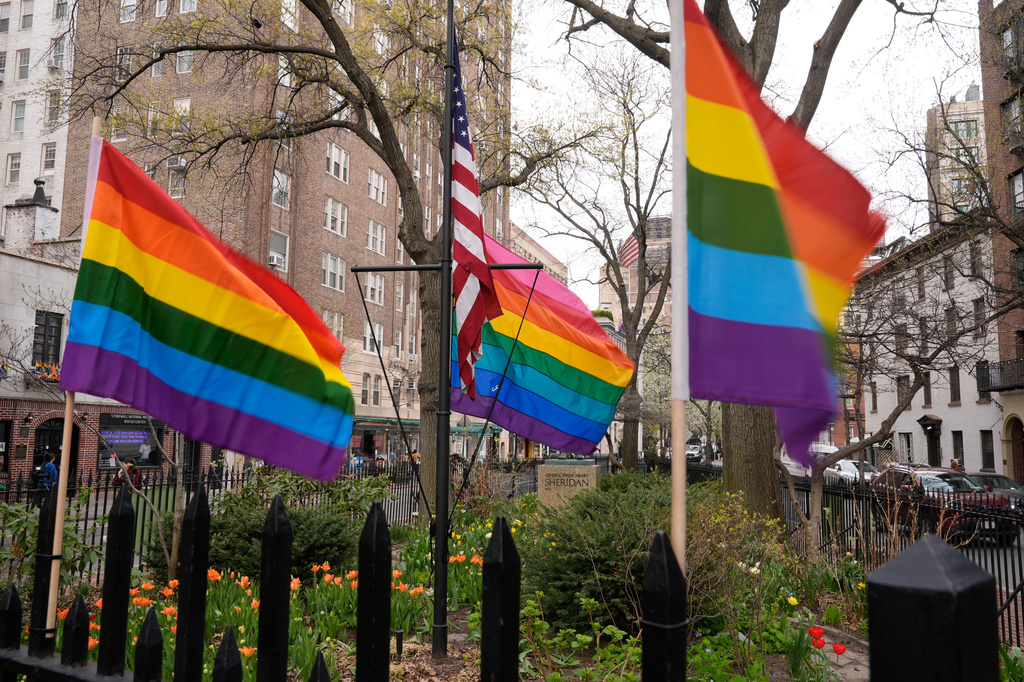 Small rainbow Pride flags are displayed near a flagpole with a larger Pride flag at the Stonewall National Monument in New York, Monday, April 13, 2026. (AP Photo/Seth Wenig)