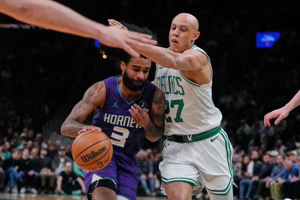 Boston Celtics guard Jordan Walsh (27) traps Charlotte Hornets guard Coby White (3) during the first half of an NBA basketball game, Wednesday, March 4, 2026, in Boston. (AP Photo/Charles Krupa)
