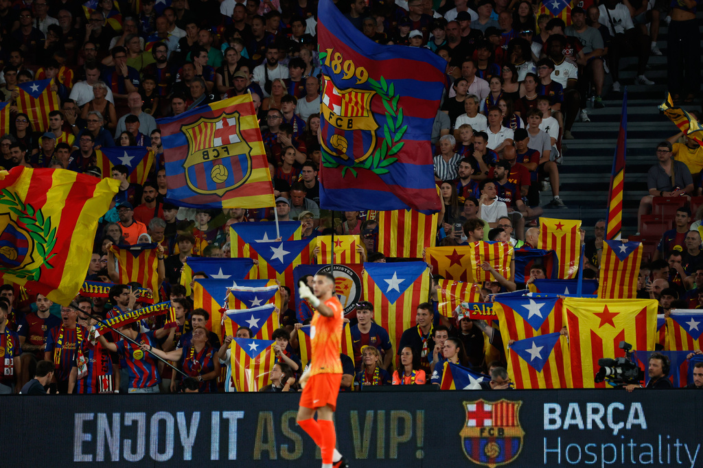 Supporters lift independence flags during a Spanish La Liga soccer match between Barcelona and Athletic in Barcelona, Spain, Thursday, Aug. 27, 2026. (AP Photo/Joan Monfort)