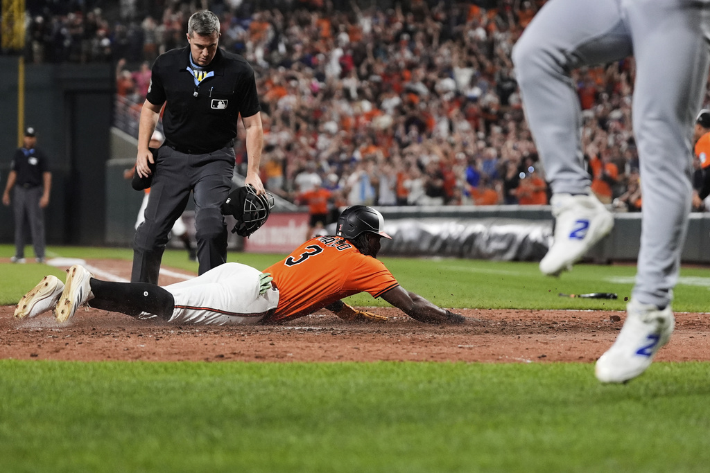 Baltimore Orioles' Jorge Mateo (3) slides into home plate to score on a walk-off single hit by Emmanuel Rivera during the ninth inning of a baseball game against the Los Angeles Dodgers, Saturday, Sept. 6, 2025, in Baltimore. (AP Photo/Stephanie Scarbrough)