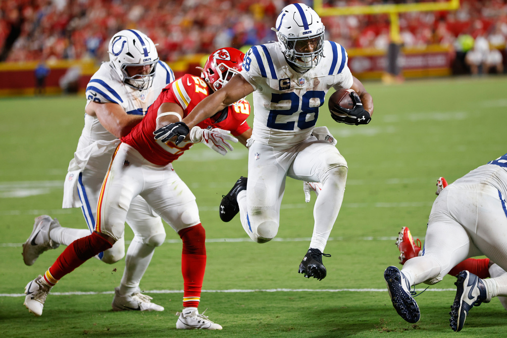 Indianapolis Colts running back Jonathan Taylor (28) scores on a touchdown run past Kansas City Chiefs safety Jaden Hicks (21) during the second half of an NFL football game Sunday, Sept. 20, 2026, in Kansas City, Mo. (AP Photo/Colin E. Braley)