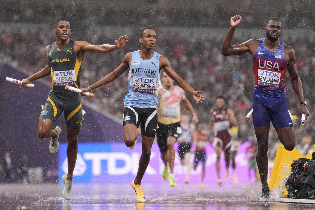 Botswana's Busang Collen Kebinatshipi crosses the line to win the gold ahead of United States' Rai Benjamin, silver, and South Africa's Zakithi Nene, bronze, in the men's 4 X 400 meters relay at the World Athletics Championships in Tokyo, Sunday, Sept. 21, 2025. (AP Photo/Petr David Josek)