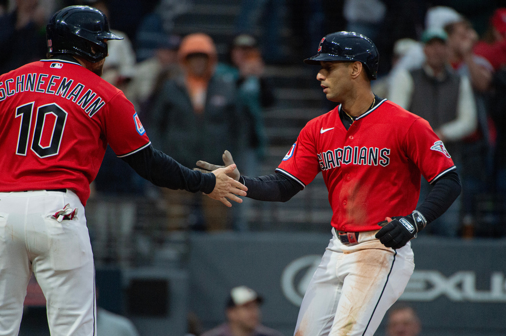 Cleveland Guardians' Daniel Schneemann (10) congratulates Brayan Rocchio, right, after Rocchio's three-run home run off Baltimore Orioles starting pitcher Dean Kremer during the fifth inning of a baseball game, Saturday, April 18, 2026, in Cleveland. (AP Photo/Phil Long)