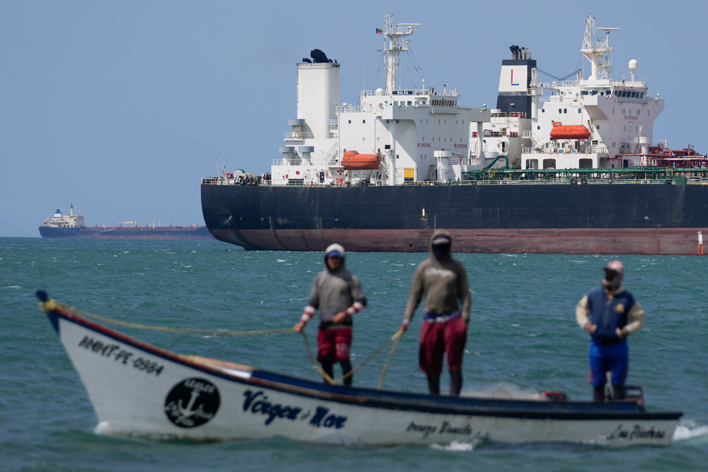 FILE - Fishermen pass an oil tanker in the Gulf of Venezuela off the shore of Punta Cardon, Venezuela, Jan. 14, 2026. (AP Photo/Matias Delacroix, FIle)