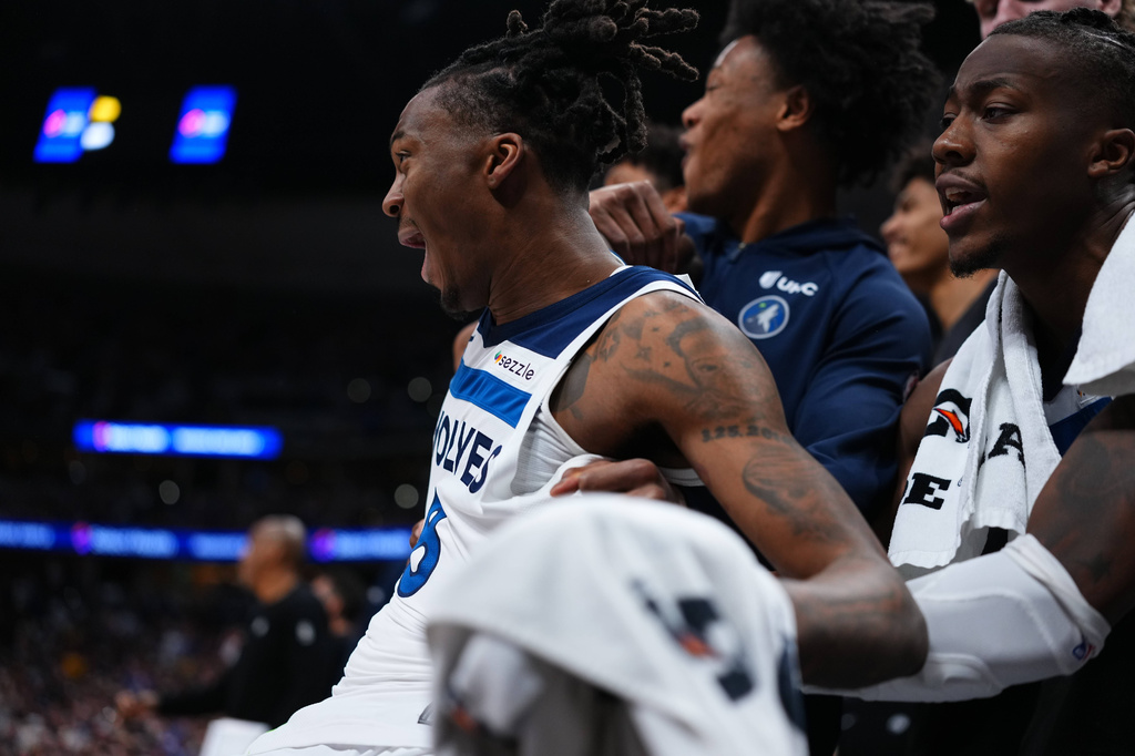 Minnesota Timberwolves guard Bones Hyland (8) celebrates on the bench against the Denver Nuggets during the second half in Game 2 of a first-round NBA playoffs basketball series Monday, April 20, 2026, in Denver. (AP Photo/Jack Dempsey)