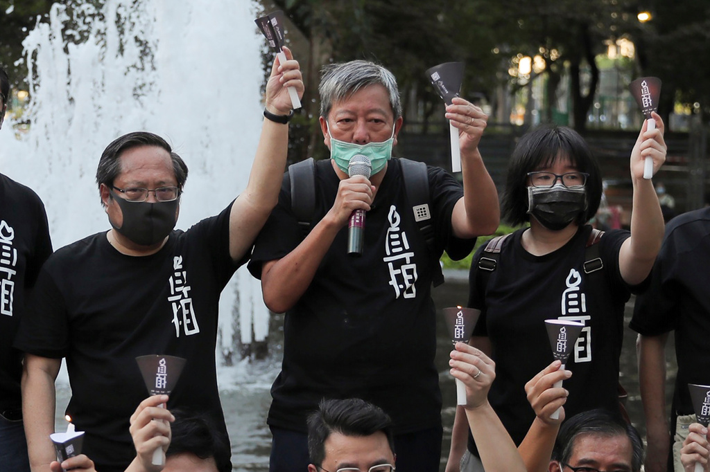 FILE - Pro-democracy activists including from left Albert Ho, Lee Cheuk-yan and Chow Hang-tung shout slogans during a gathering to mourn those killed in the 1989 Tiananmen crackdown at Victoria Park in Causeway Bay, Hong Kong on June 4, 2020. (AP Photo/Kin Cheung, File)